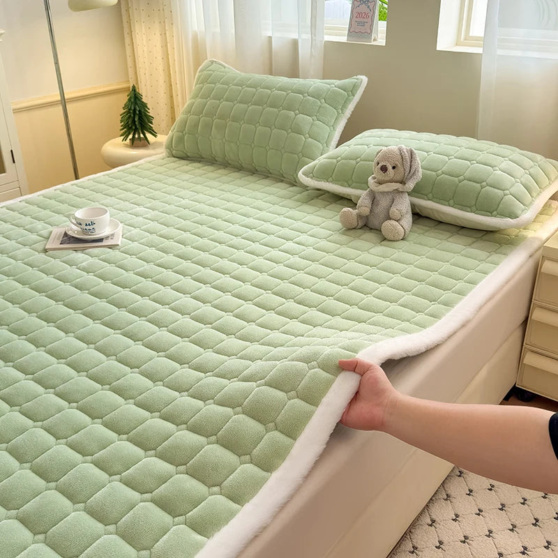 Green quilted fleece bedding with white trim and matching pillowcases.