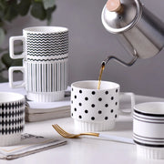 Nordic-style ceramic mug (1 unit), with various graphic prints. Stackable.