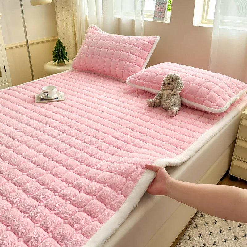 Pink quilted fleece bedding with white trim and matching pillowcases.
