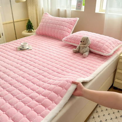 Pink quilted fleece bedding with white trim and matching pillowcases.