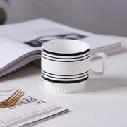 Nordic-style ceramic mug (1 unit), with various graphic prints. Stackable.
