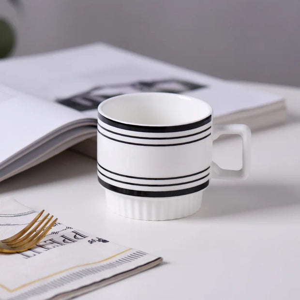 Nordic-style ceramic mug (1 unit), with various graphic prints. Stackable.