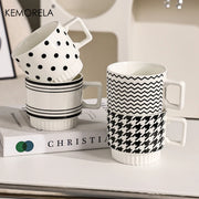 Nordic-style ceramic mug (1 unit), with various graphic prints. Stackable.