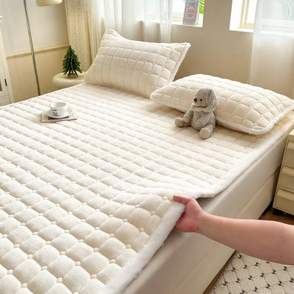 White quilted fleece bedding with matching pillowcases on a styled bed.
