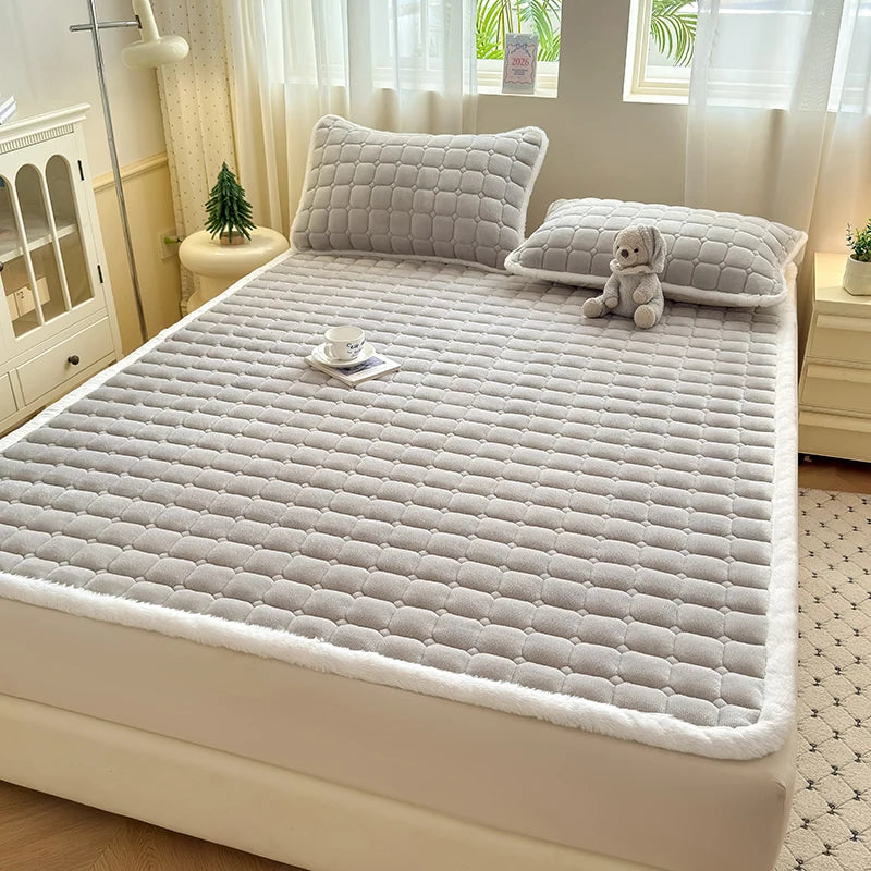 Gray quilted fleece bedding with white trim and matching pillowcases.