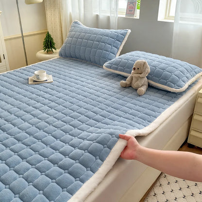 Blue quilted fleece bedding with white trim and matching pillowcases.