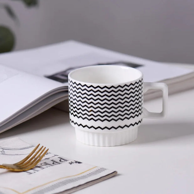 Nordic-style ceramic mug (1 unit), with various graphic prints. Stackable.