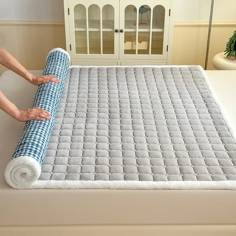 Gray fleece sheet rolled back to reveal blue and white checked backing.