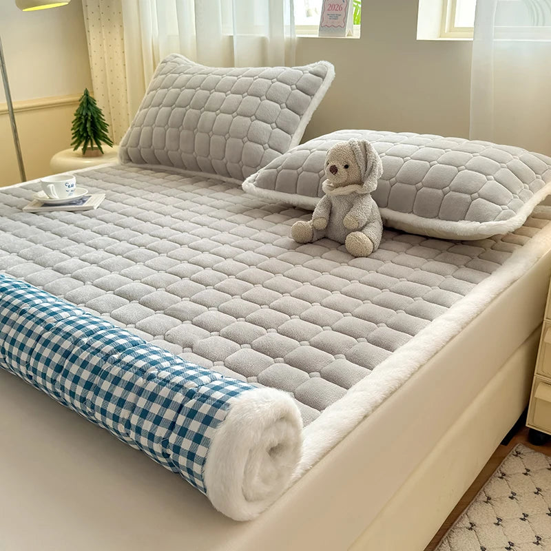 Partially rolled gray fleece sheet showing blue and white checked backing.