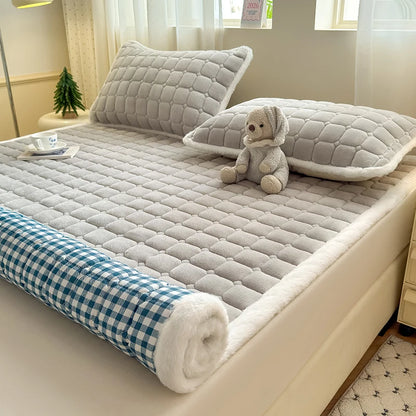 Partially rolled gray fleece sheet showing blue and white checked backing.