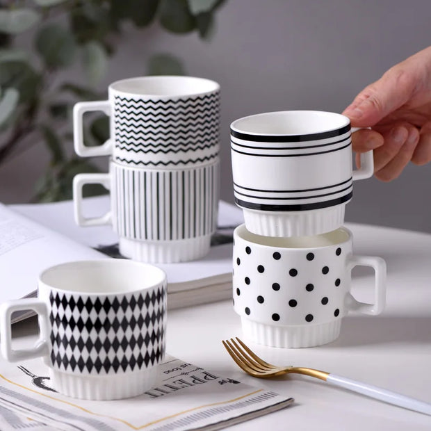 Nordic-style ceramic mug (1 unit), with various graphic prints. Stackable.