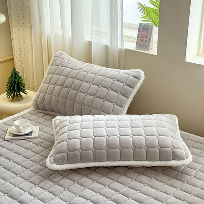 Gray quilted fleece pillowcases with white edging on matching bedding.
